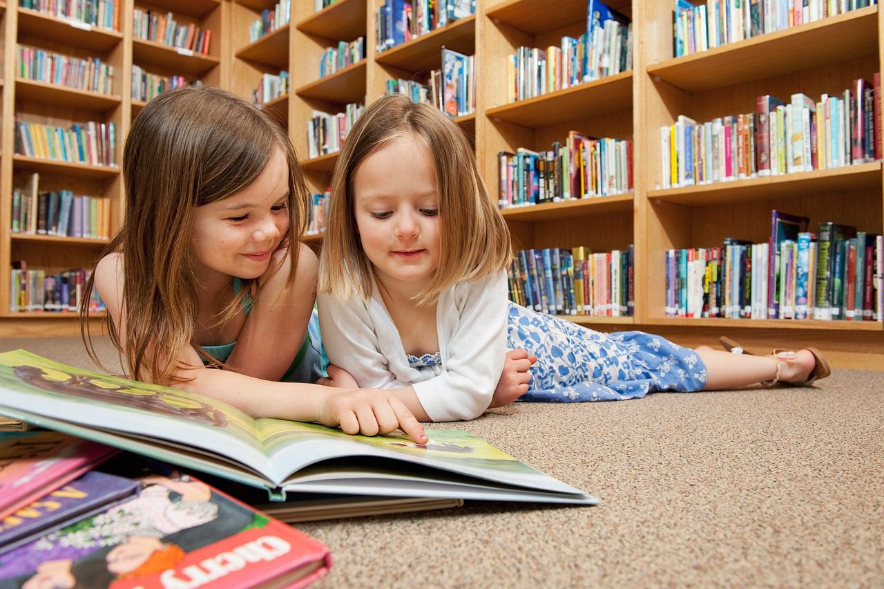 Bambini che leggono libri in biblioteca. libro da colorare